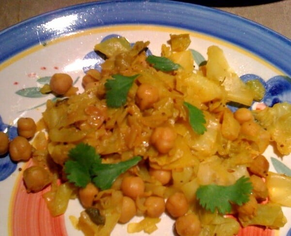 Patta Gobi Chole served on a blue patterned plate