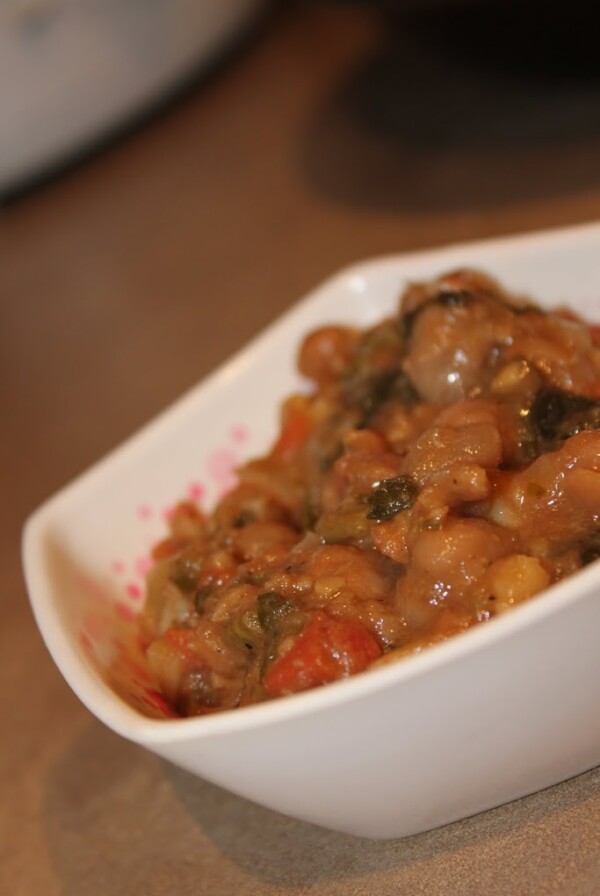 Palak Chole (spinach curry) in a white bowl on a wooden work surface