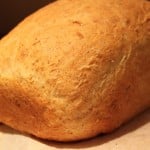 An olive oil sandwich loaf on a wooden chopping board