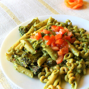 Basil cashew pesto with penne served on a white plate