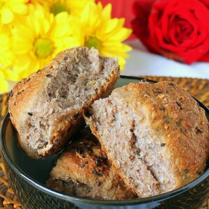 Strawberry cauliflower bread rolls in a dark blow with flowers in the background