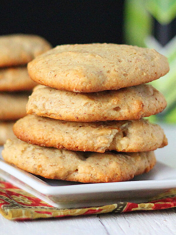 Coconut cookies stacked on a white plate
