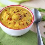 Pigeon pea soup in a white bowl on a green tablecloth