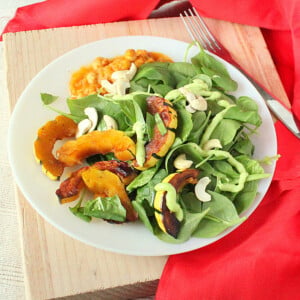 Maple Glazed Delicata Squash served on a white plate with salad