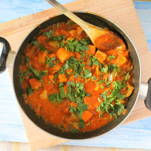 Kadai Gobi in a pan with a wooden spoon in it.