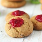 Cranberry thumbprint cookies on a wooden work surface