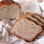 Slices of No Knead Strawberry Wheat Bread Loaf on white fabric