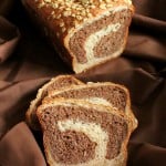 Vanilla wheat bread cut in half on a fabric background