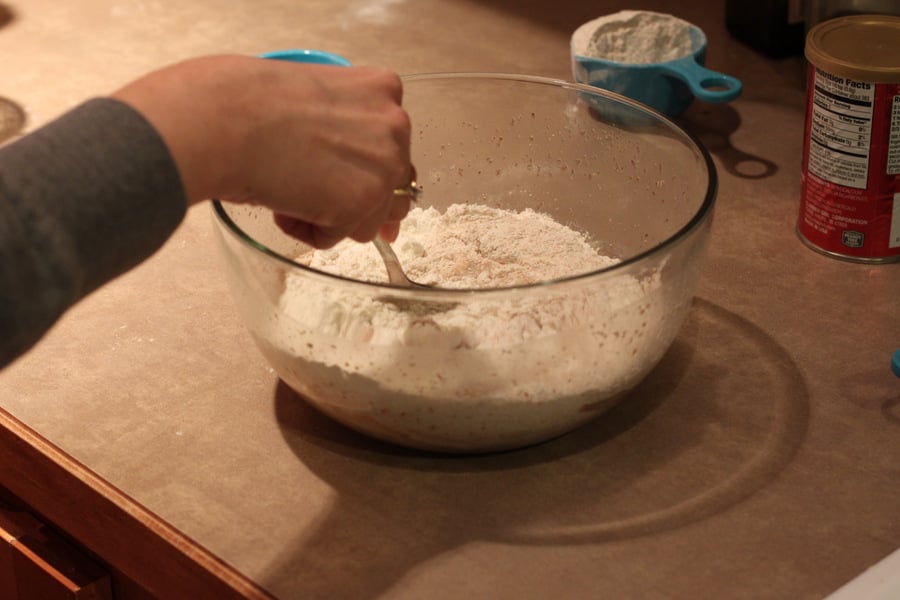 vegan cinnamon rolls dry ingredients being mixed with activated yeast to make vegan cinnamon rolls recipe