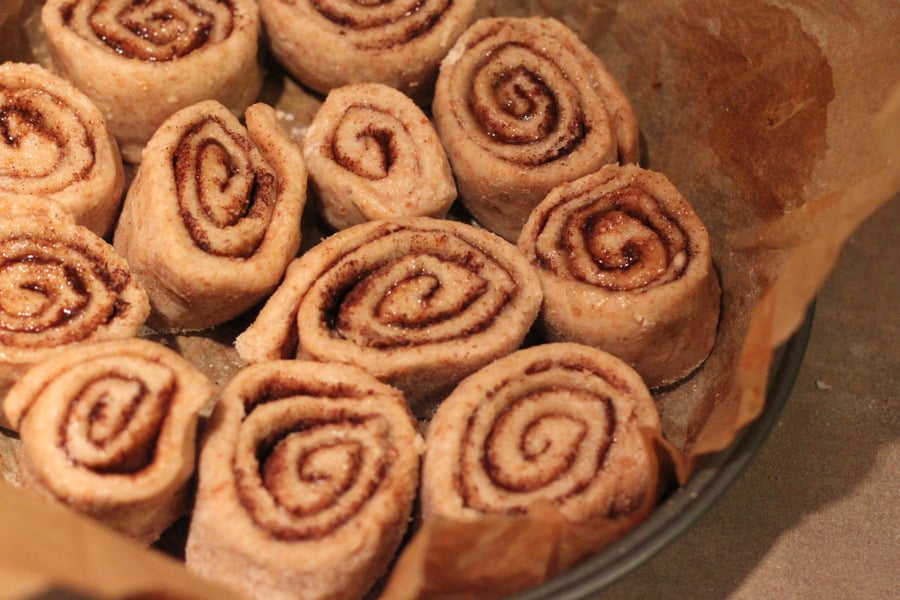 vegan cinnamon rolls vegan cinnamon rolls proofing in a round parchment-lined cake pan