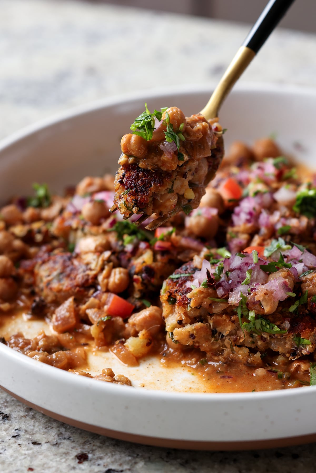 fork taking a bite of tikki chole
