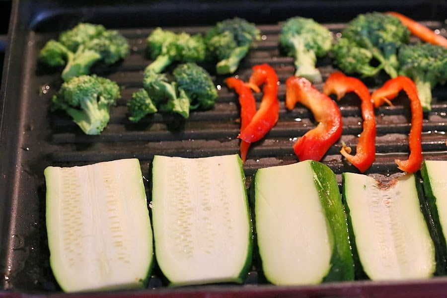 vegetable sandwich sliced zucchini, red bell peppers and broccoli florets in a grill pan
