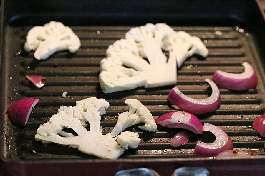 vegetable sandwich cauliflower and onion slices roasting in a grill pan