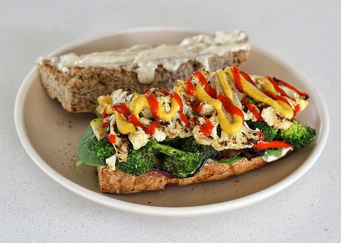 vegetable sandwich open-faced vegan grilled vegetable sandwich with plenty of sriracha mayo and mustard drizzled on top