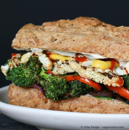 vegetable sandwich close-up side view of a roasted vegetable sandwich with sriracha mayo on a spelt almond flour bun