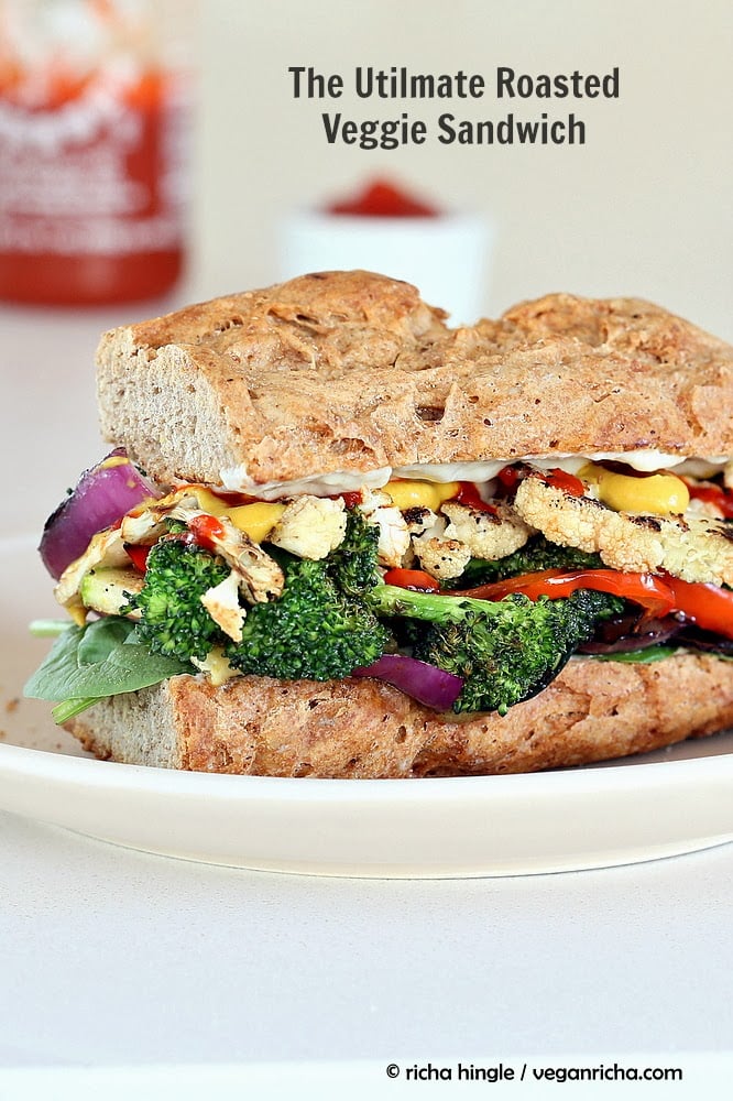 vegetable sandwich side view of a healthy vegan roasted vegetable sandwich with sriracha mayo and mustard