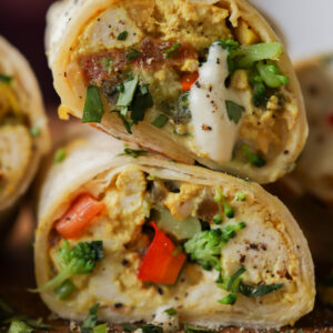 vegan scramble wrap cut in half, so you can see the fillings