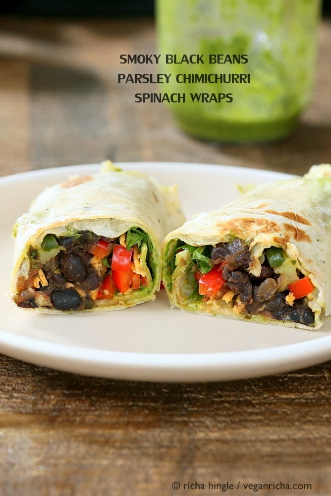 vegan wrap recipe side view of two halves of a vegan wrap with black beans, bell pepper and vegan cheese on a white plate