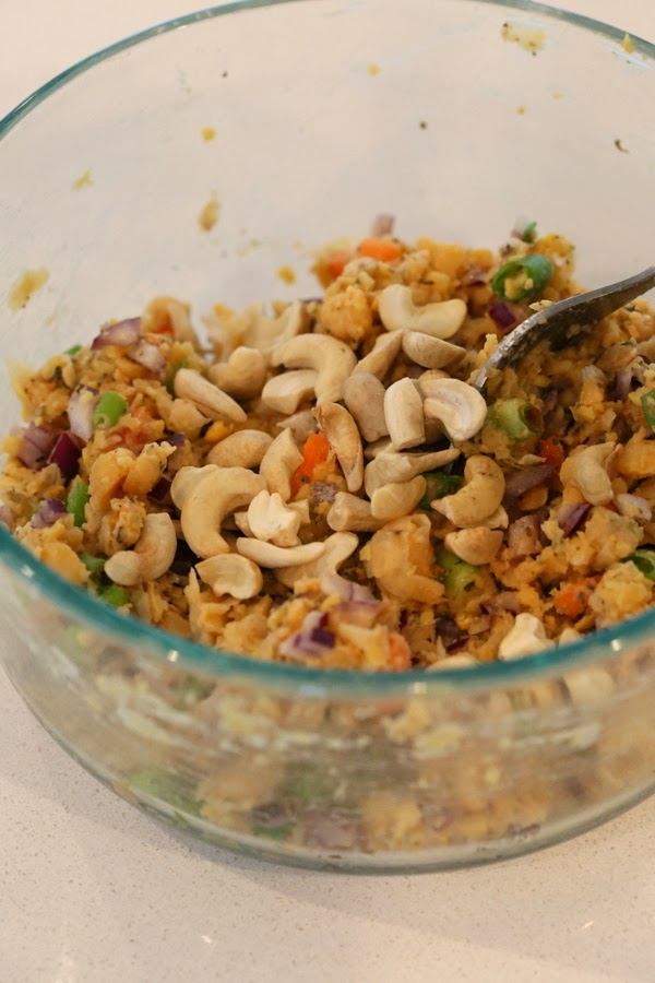 stuffed portobello mushrooms cashews being added to vegan filling for making stuffed portobello mushrooms recipe