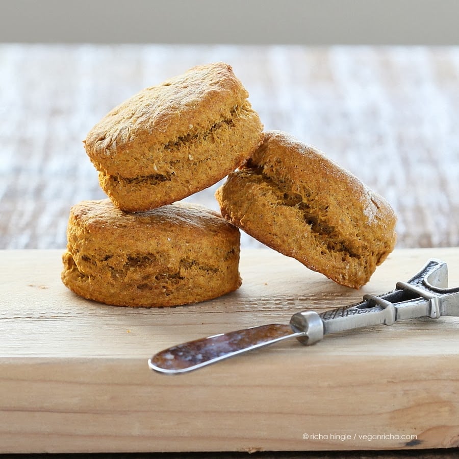 sweet potato biscuits three vegan sweet potato biscuits made with spelt flour on a wooden board with a butter knife