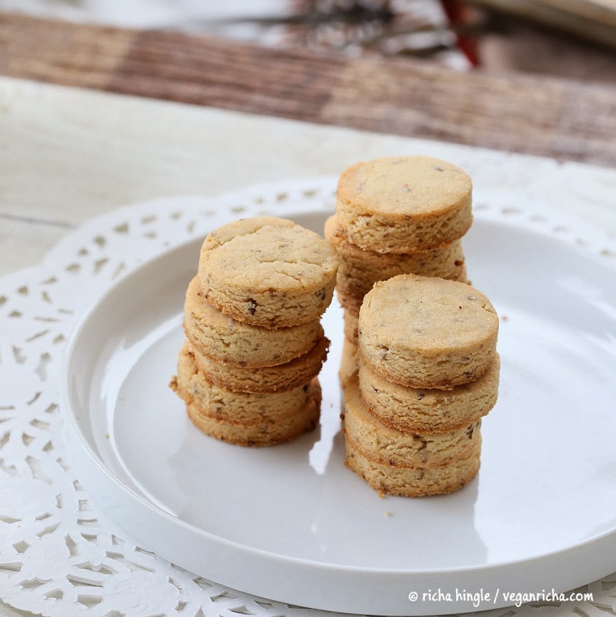 vegan sugar cookies vegan sugar cookies stacked on a white cookie platter