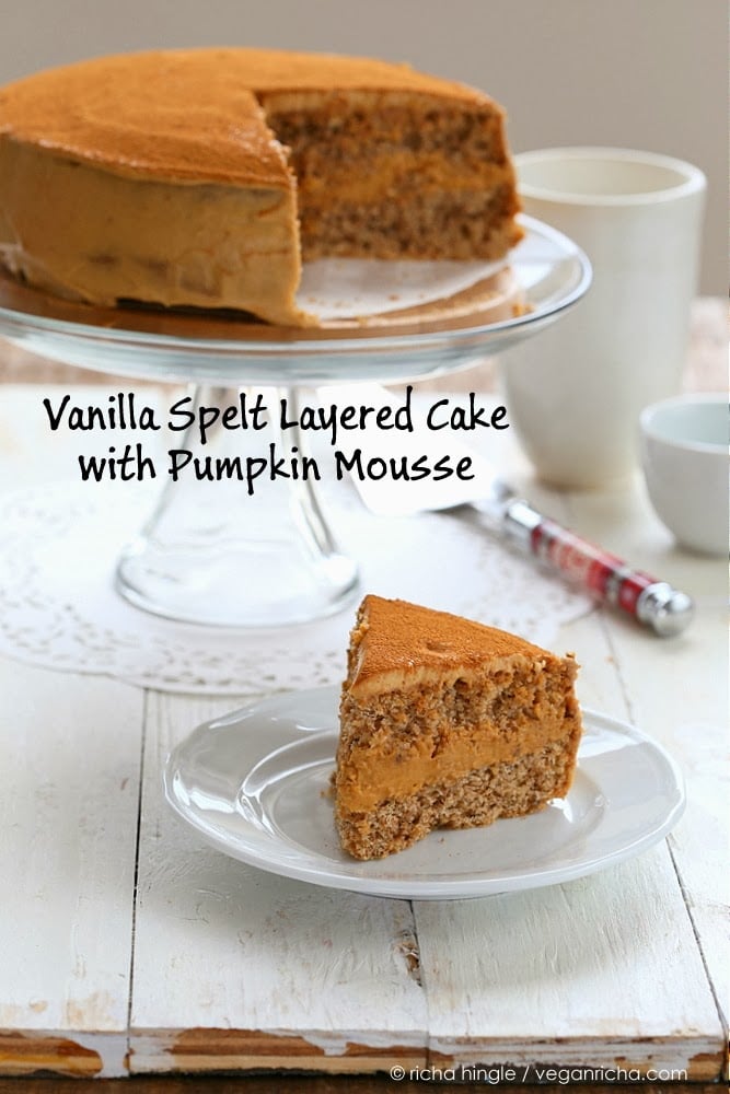 a slice of vegan pumpkin mousse cake on a small plate with the cut cake in the background