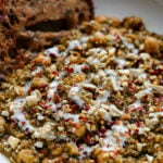 chickpea lentil spinach stew in a bowl with bread to dip