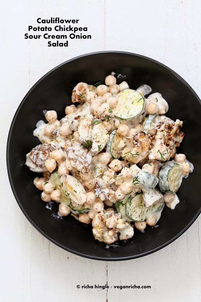 Vegan potato salad with chickpeas and cauliflower in a black bowl