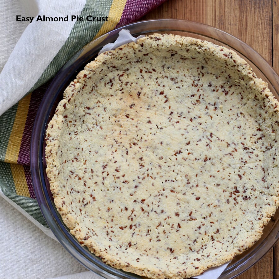 overhead shot of a baked vegan almond flour pie crust in a pyrex pie dish 