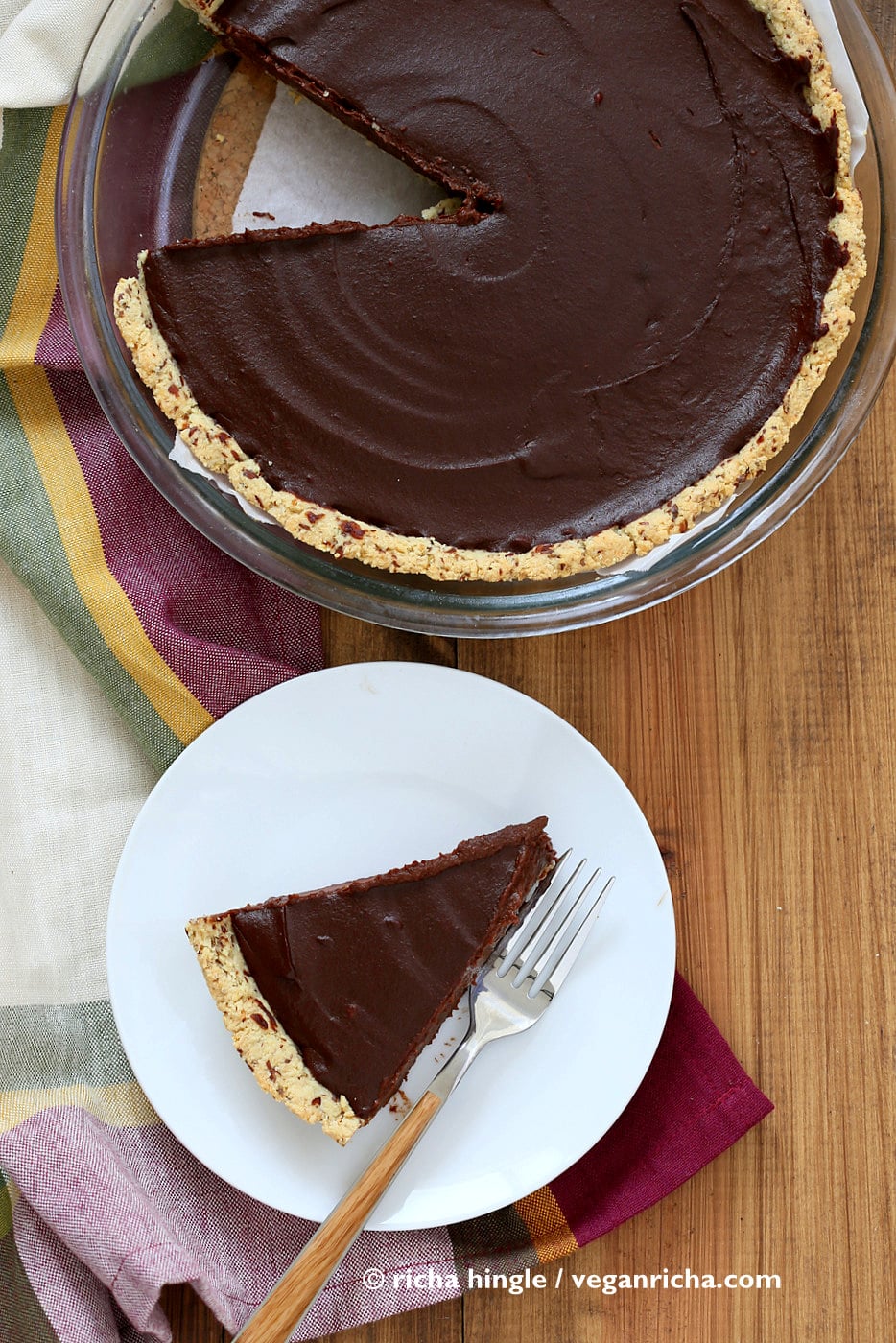 vegan pumpkin pie overhead shot of a Vegan Chocolate Pumpkin Pie in a pyrex pie dish with plated slice of pie on the side