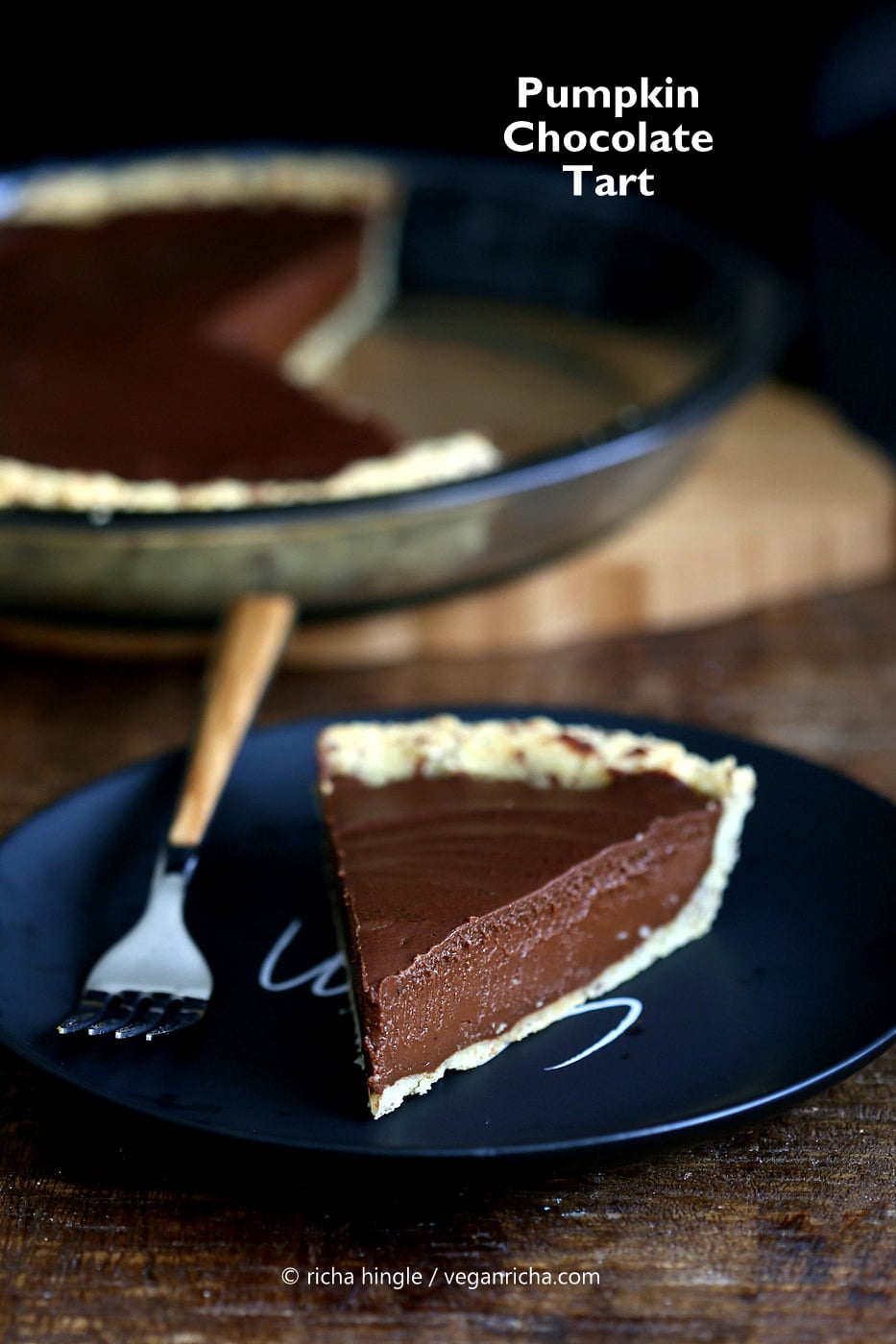 vegan chocolate pumpkin pie a slice of Vegan Chocolate Pumpkin Pie on a black plate with a fork on the side