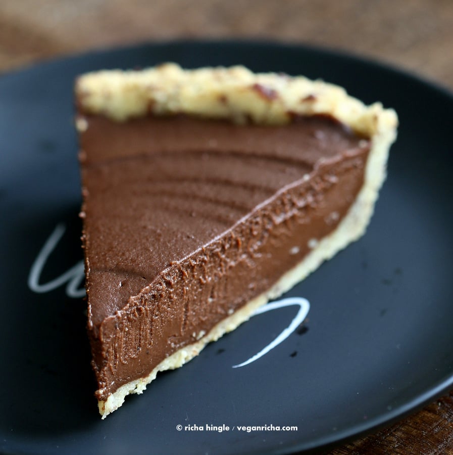 Vegan Pumpkin Pie close-up of a slice of Vegan Chocolate Pumpkin Pie with Almond Flour Pie Crust on a black plate