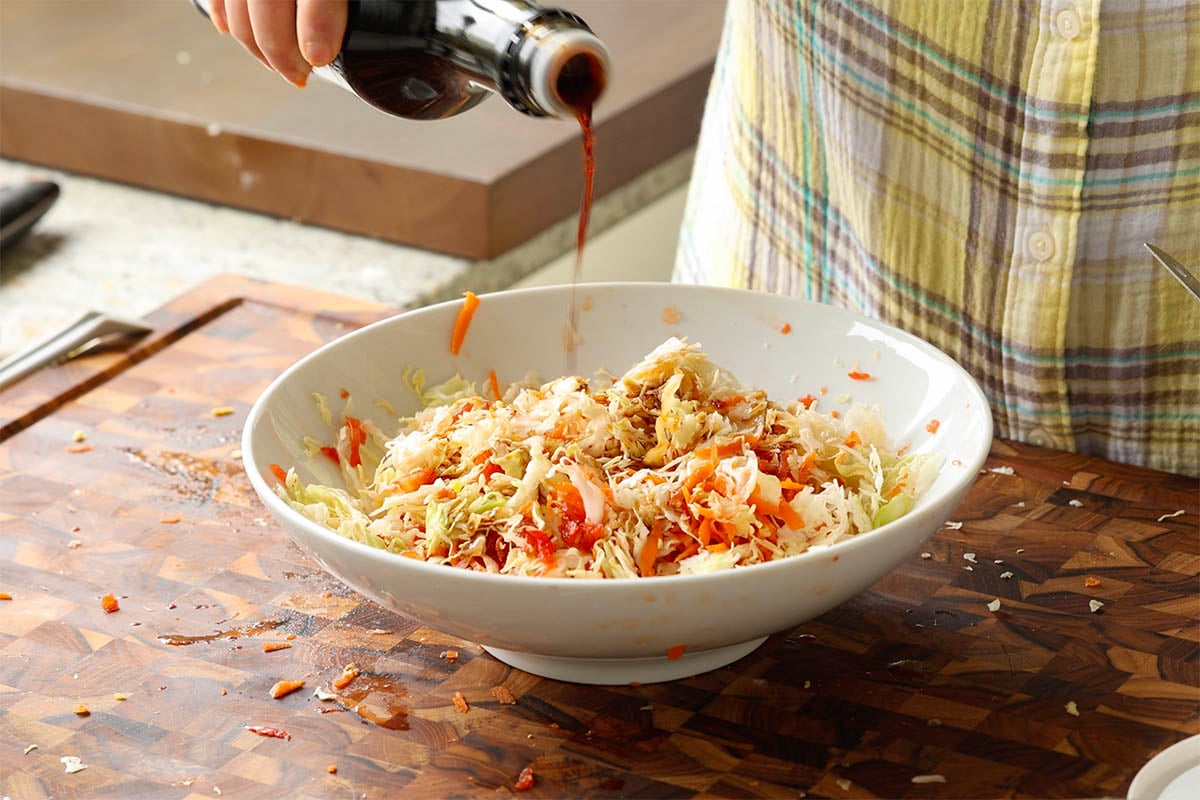 adding soy sauce to the veggies