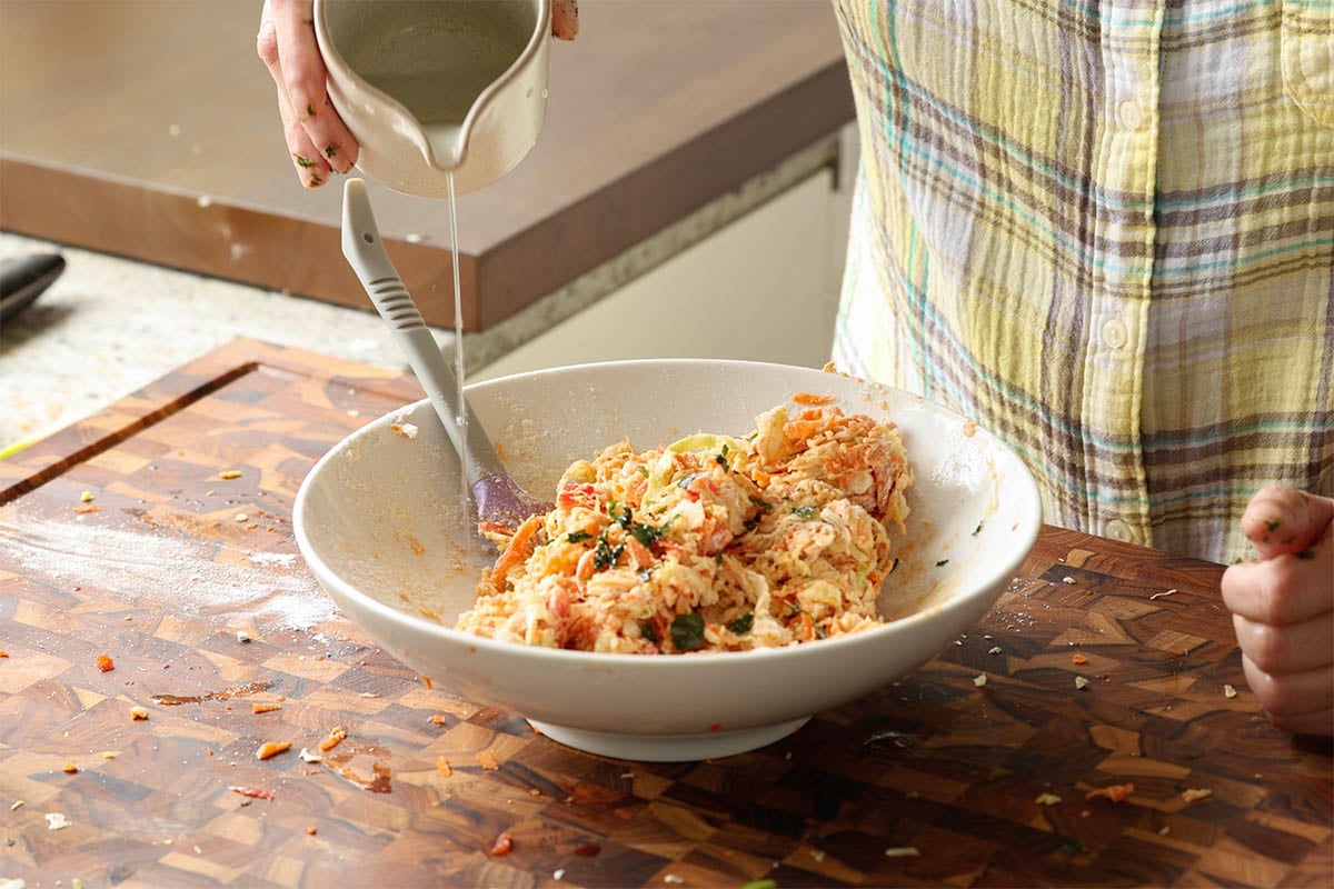 adding water to the savory pancake batter