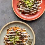 plates of Japanese cabbage carrot pancakes with sauces and green onion