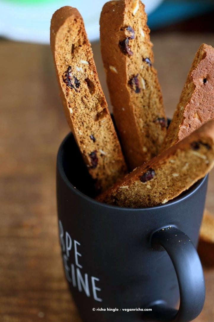 Vegan Gingerbread Biscotti with cranberries, almonds, candied ginger. Easy Crispy Spiced Biscotti Recipe to dunk in a cup of tea. Drizzle with white or dark chocolate. | VeganRicha.com #vegan #gingerbread #biscotti #recipe