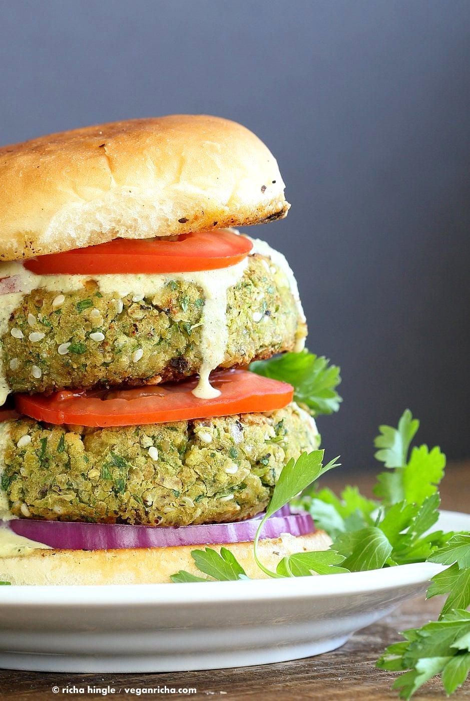 Easy Vegan Falafel Burger. Chickpea patties with tahini dressing and hummus make for a filling and flavorful burger. Vegan Soy-free Recipe. Can be made gluten-free | VeganRicha.com