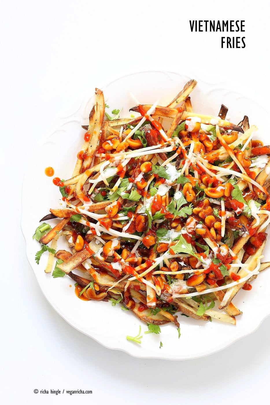 Baked Vietnamese fries. Baked Potato strips, loads of cilantro and basil, bean sprouts, nuts in sweet chile sauce, sriracha and vegan mayo! Banh mi Sandwich in fries form. Vegan Gluten-free Recipe. | VeganRicha.com