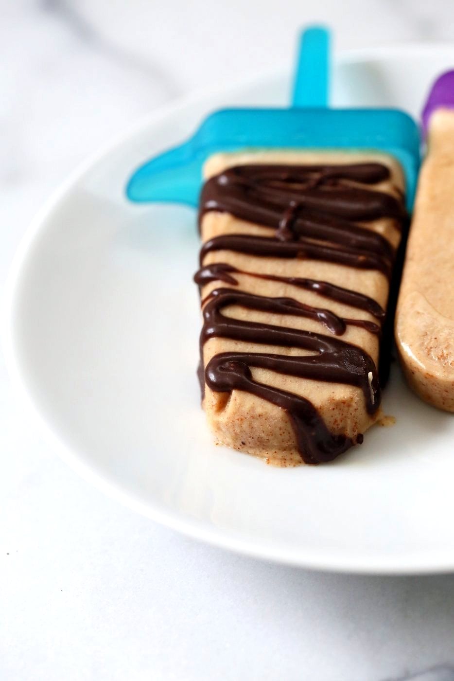 These Chocolate Peanut Butter Ice Cream Popsicles are like Peanut Butter Cup pops. Creamy Nut butter ice cream drizzled with melted chocolate. Vegan Gluten-free Recipe | VeganRicha.com