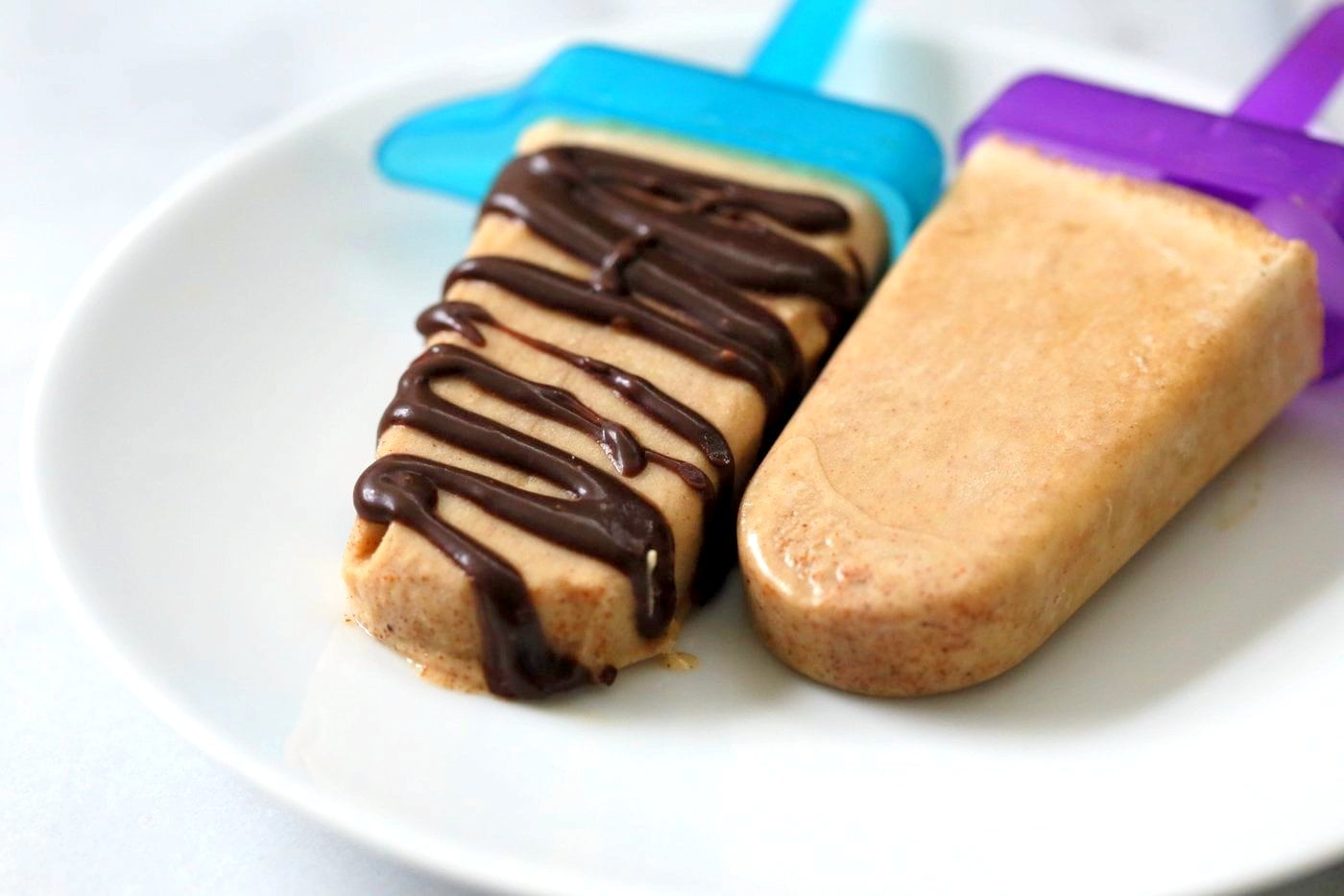 These Chocolate Peanut Butter Ice Cream Popsicles are like Peanut Butter Cup pops. Creamy Nut butter ice cream drizzled with melted chocolate. Vegan Gluten-free Recipe | VeganRicha.com