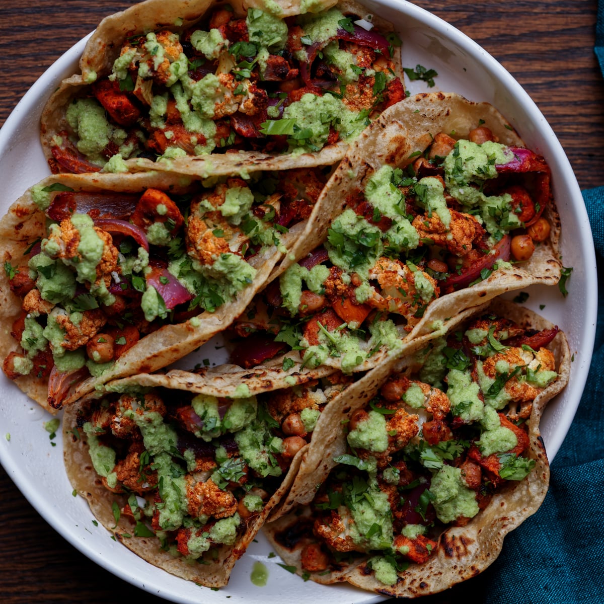 cauliflower sweet potato tacos on a plate with coconut chutney and garnishes