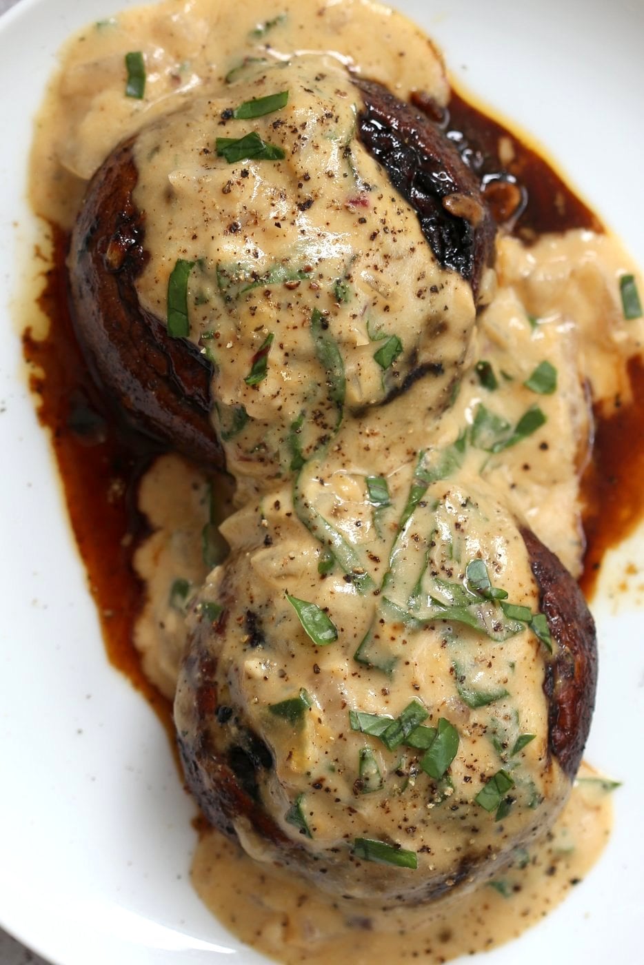 Grilled Portobello Mushrooms with Garlic Sauce. Grilled or Baked Marinated Portabella Mushrooms served with creamy gravy. #Vegan #Glutenfree #Recipe #veganricha | VeganRicha.com