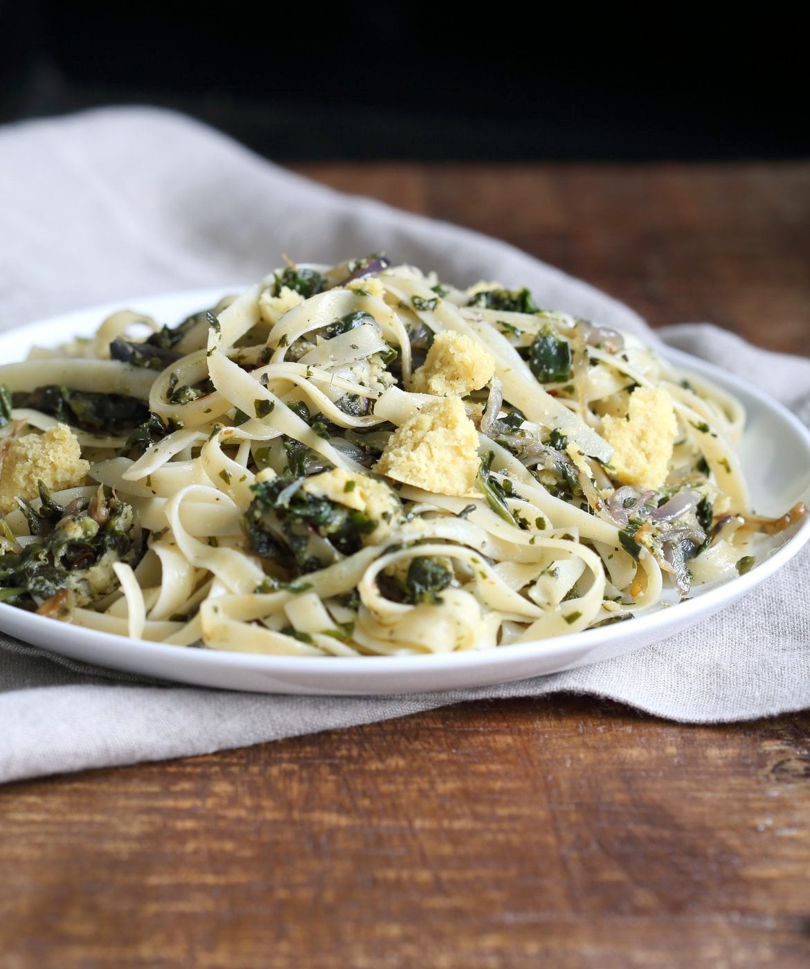 Fettuccine with Caramelized Onions, Greens and Vegan Feta - ish cheese. Easy Weeknight meal. Make the cheese ahead, then the dish is 1 Pot and 30 minutes. #Vegan, can be Gluten-free, Soy-free #veganricha | VeganRicha.com
