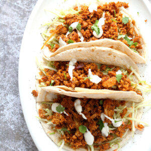 Mango BBQ Soy Curls or Jackfruit Tacos. Shredded Soy Curls or Jackfruit make a an amazing carrier for bbq sauce. Some Mango or other fruit puree takes it to the next level. Serve in sandwiches or tacos with slaw. #Vegan #Glutenfree #Recipe #veganricha | VeganRicha.com