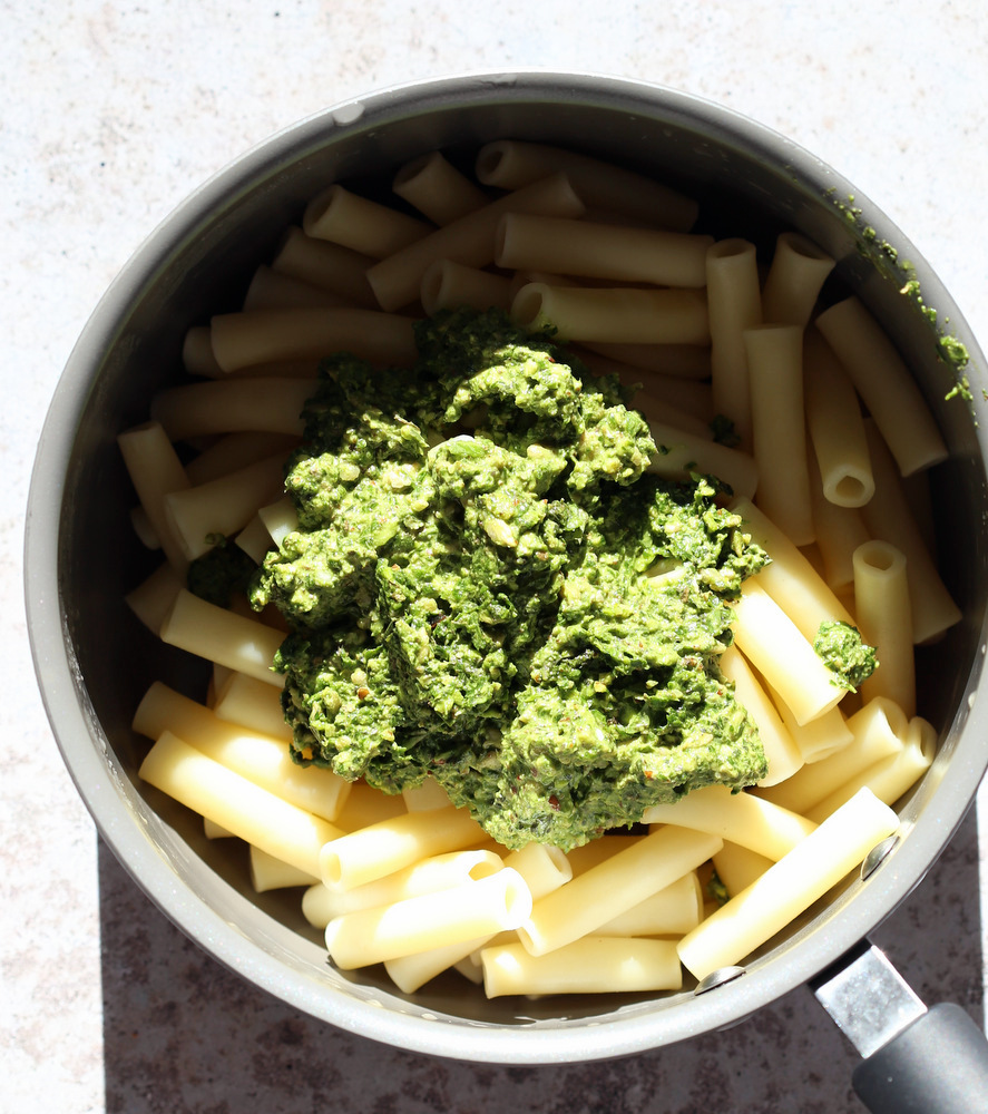 Vegan Pesto over pasta in a saucepan
