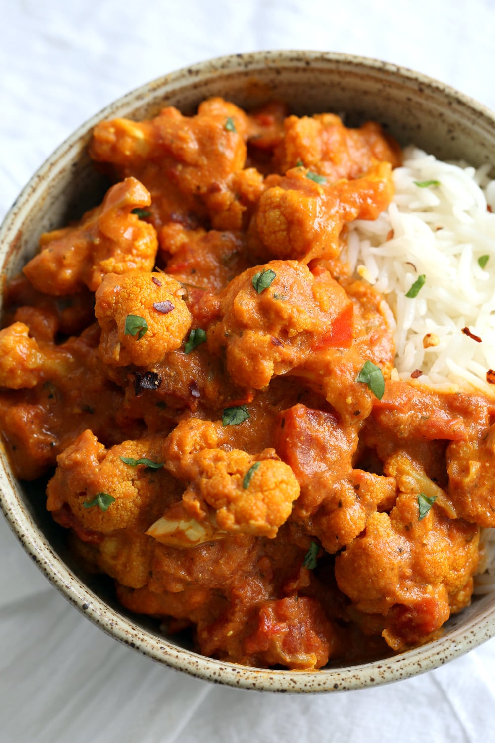 Vegan Cauliflower Tikka Masala in a speckled bowl