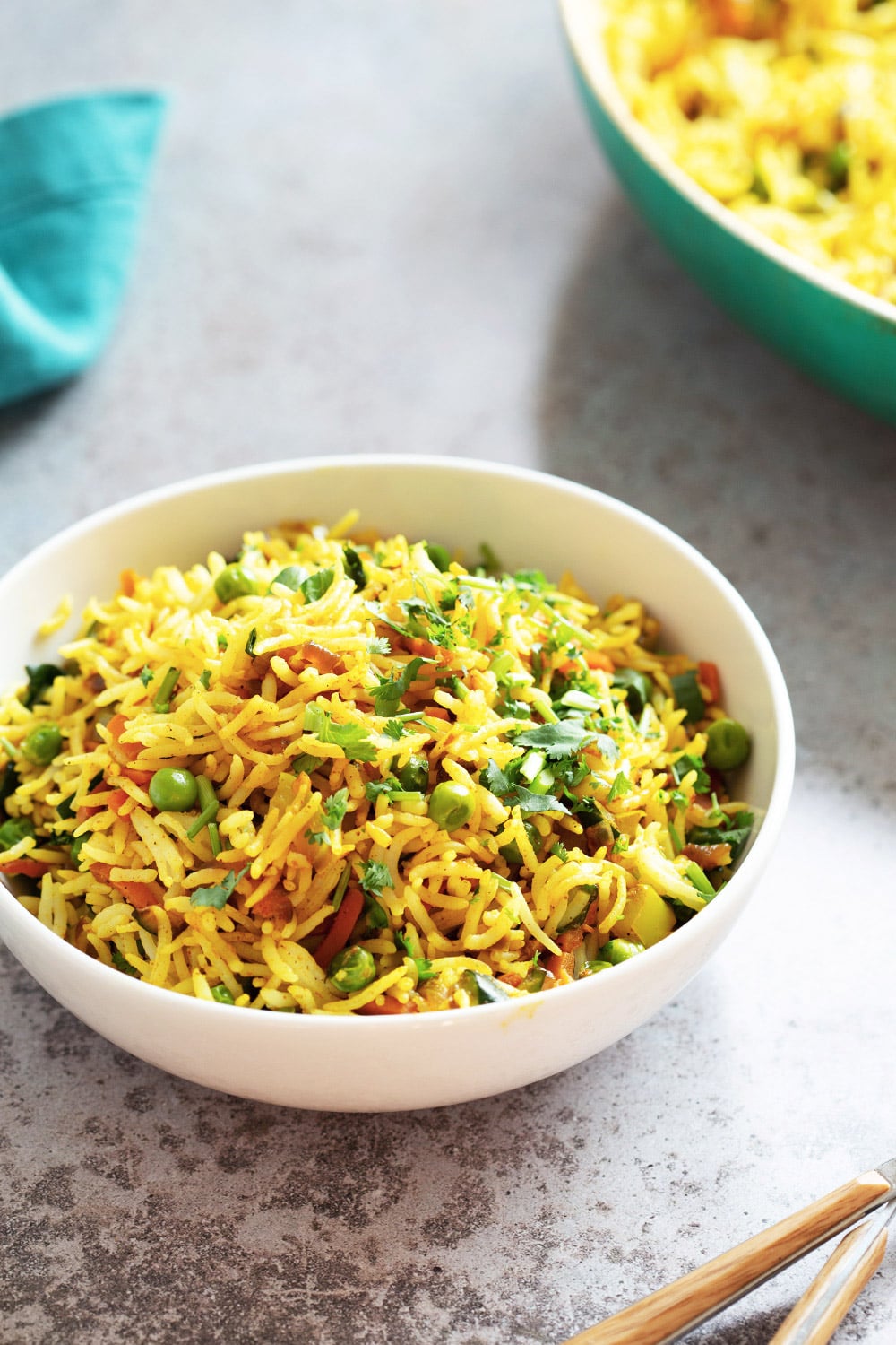 Curry fried rice in a white bowl on a work surface