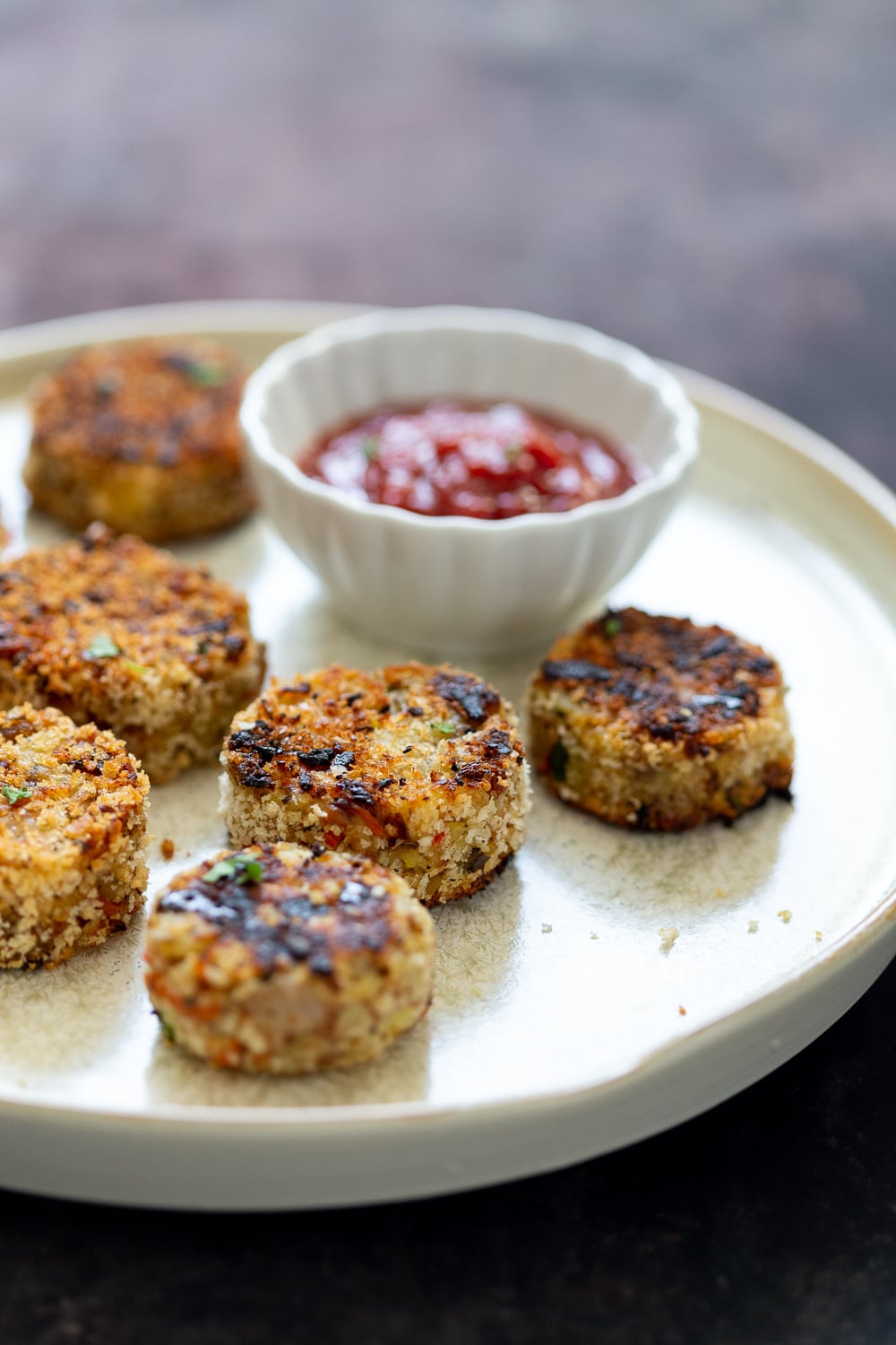 Potato Cauliflower Patties Vegan Eggless version on a Plate. Side View with Ketchup