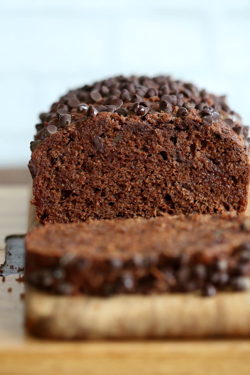 Vegan Chocolate Gingerbread Cake sliced and placed against white backdrop