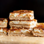 Sliced Vegan Apple Custard Squares stacked on wood board